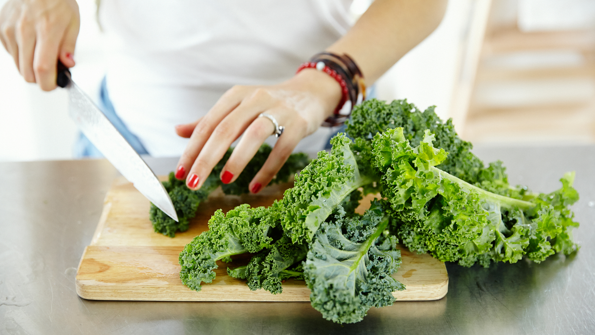 catherine-cuello-chopping-kale-for-her-sweet-potato-kale-and-chives-recipe-foodadit