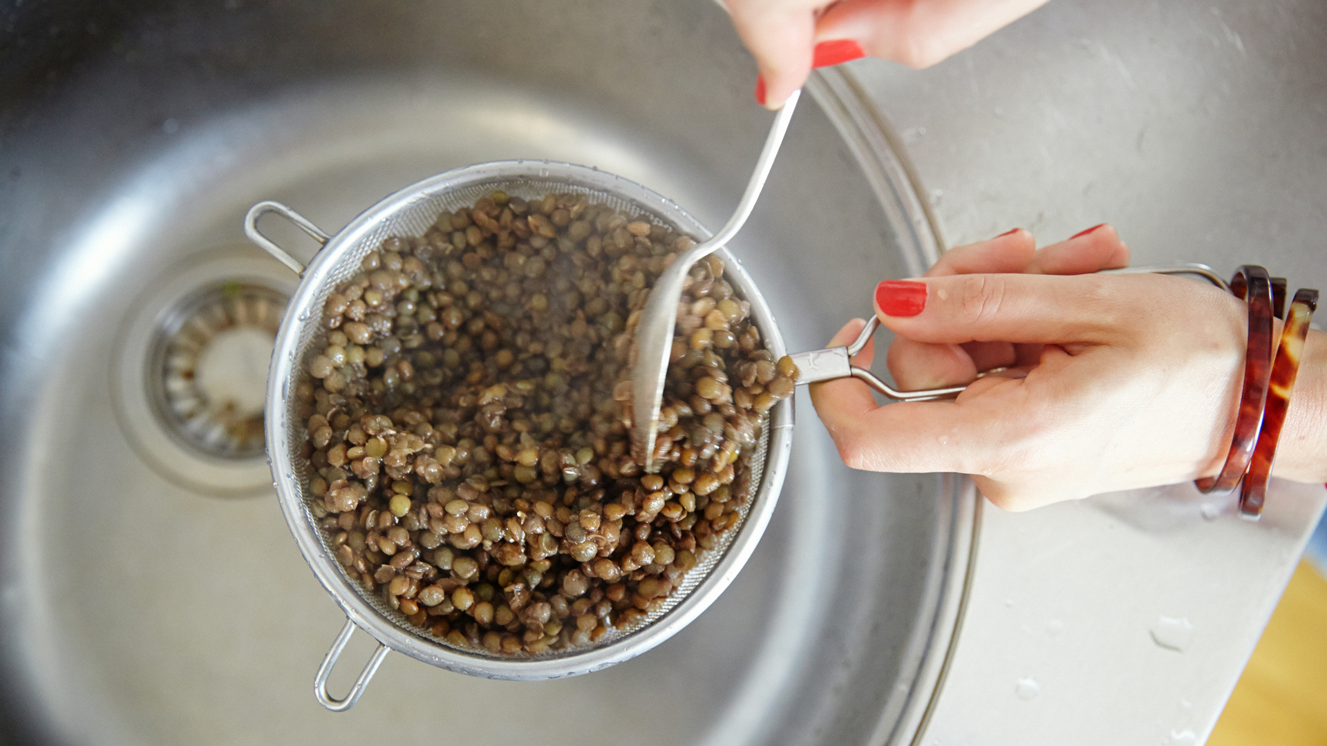 Catherine Cuello-Fuente draining the puy lentils for her French Lentils with a Tonne of Herbs recipe