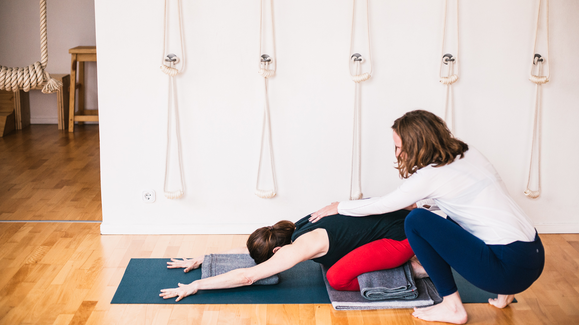 Alanna Lawley and Elizabeth Smullens Brass - Iyengar Yoga General Level Sequence - Child's pose – Adho Mukha Virasana with blankets