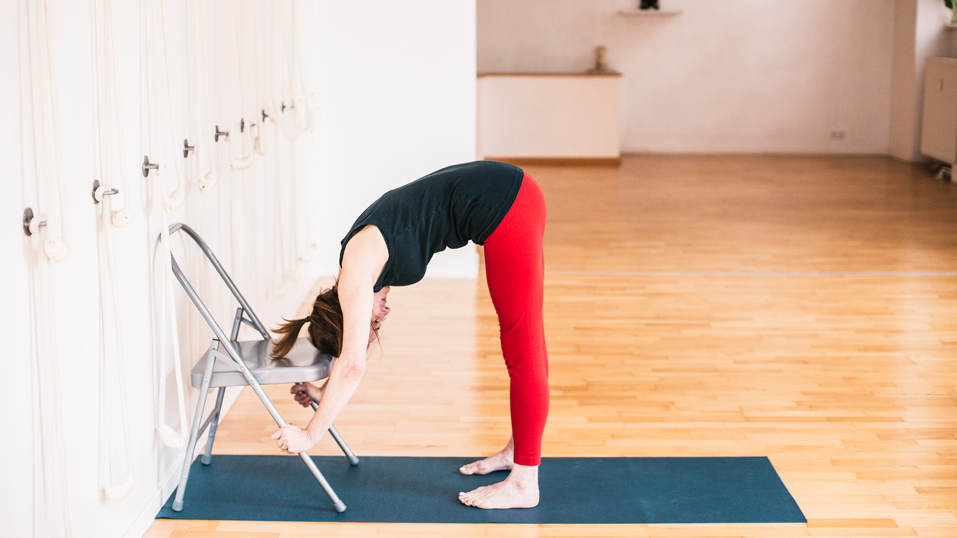 Iyengar Yoga General Level Sequence - Standing forward bend - Uttanasana with hands on yoga chair
