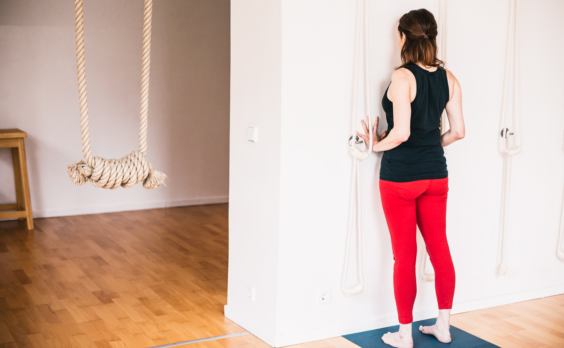 Iyengar Yoga General Level Sequence - Standing forward bend - Uttanasana with hands on the wall